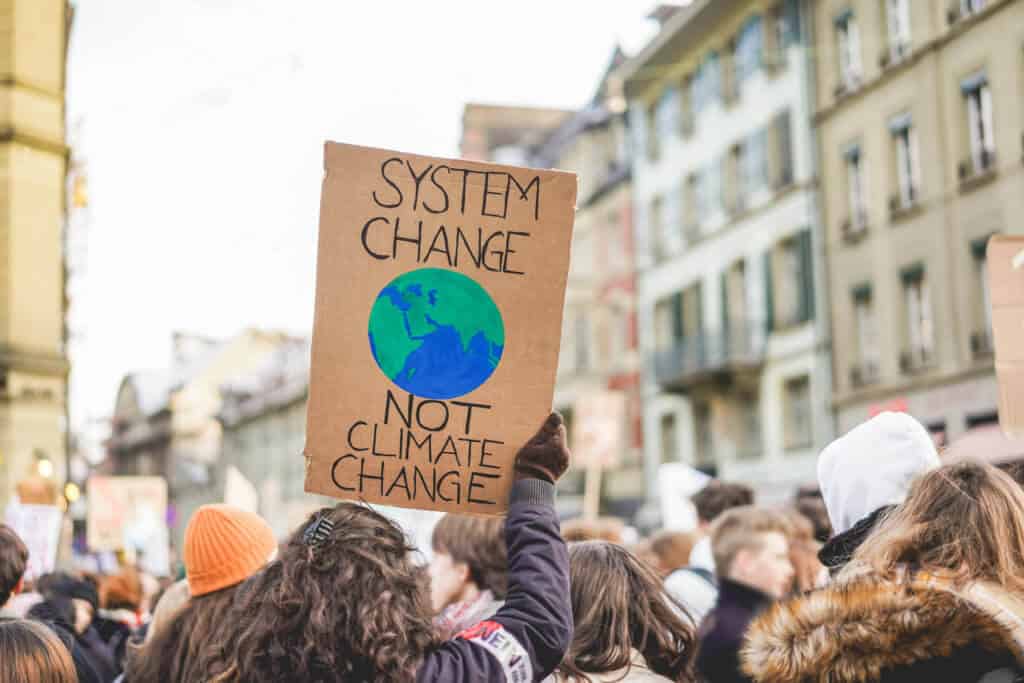 Group of demonstrators on road, young people fight for climate change - Global warming and enviroment concept - Focus on banner