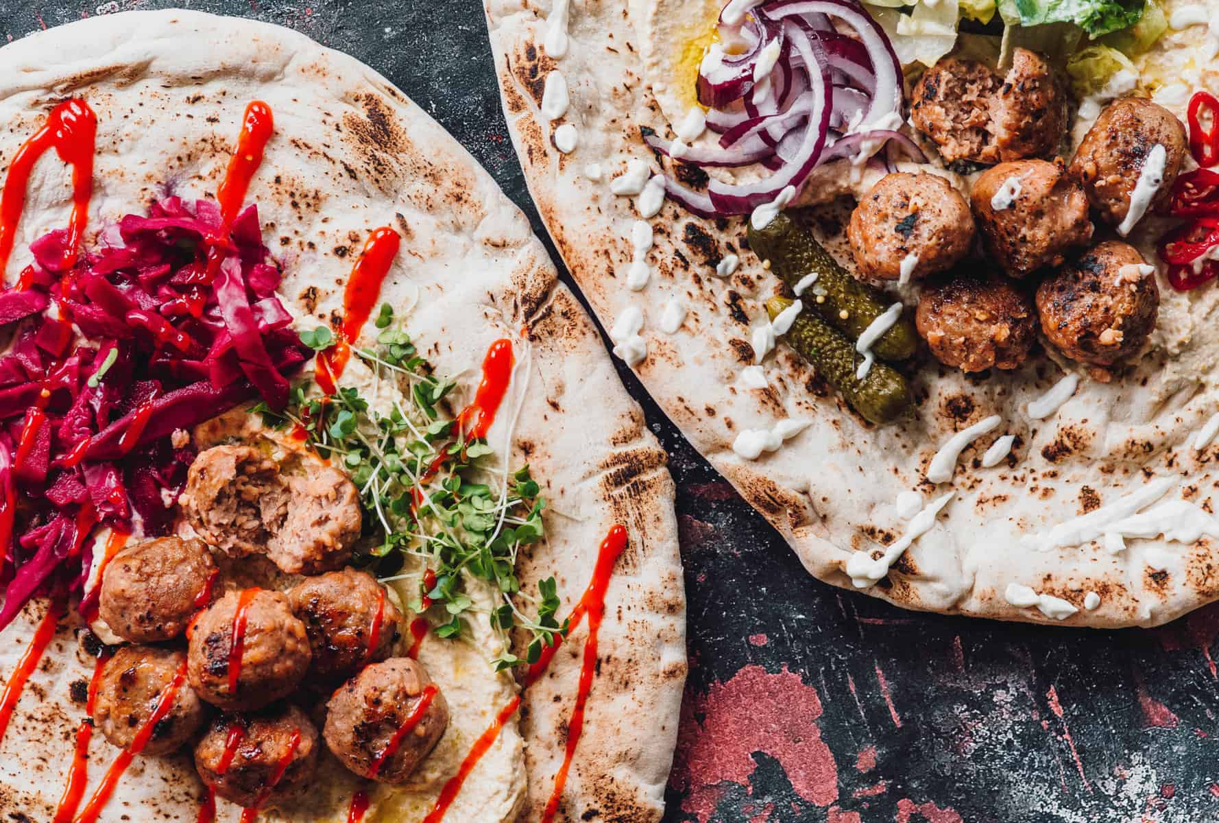 plant-based meatballs over pita bread served with onions and sauce