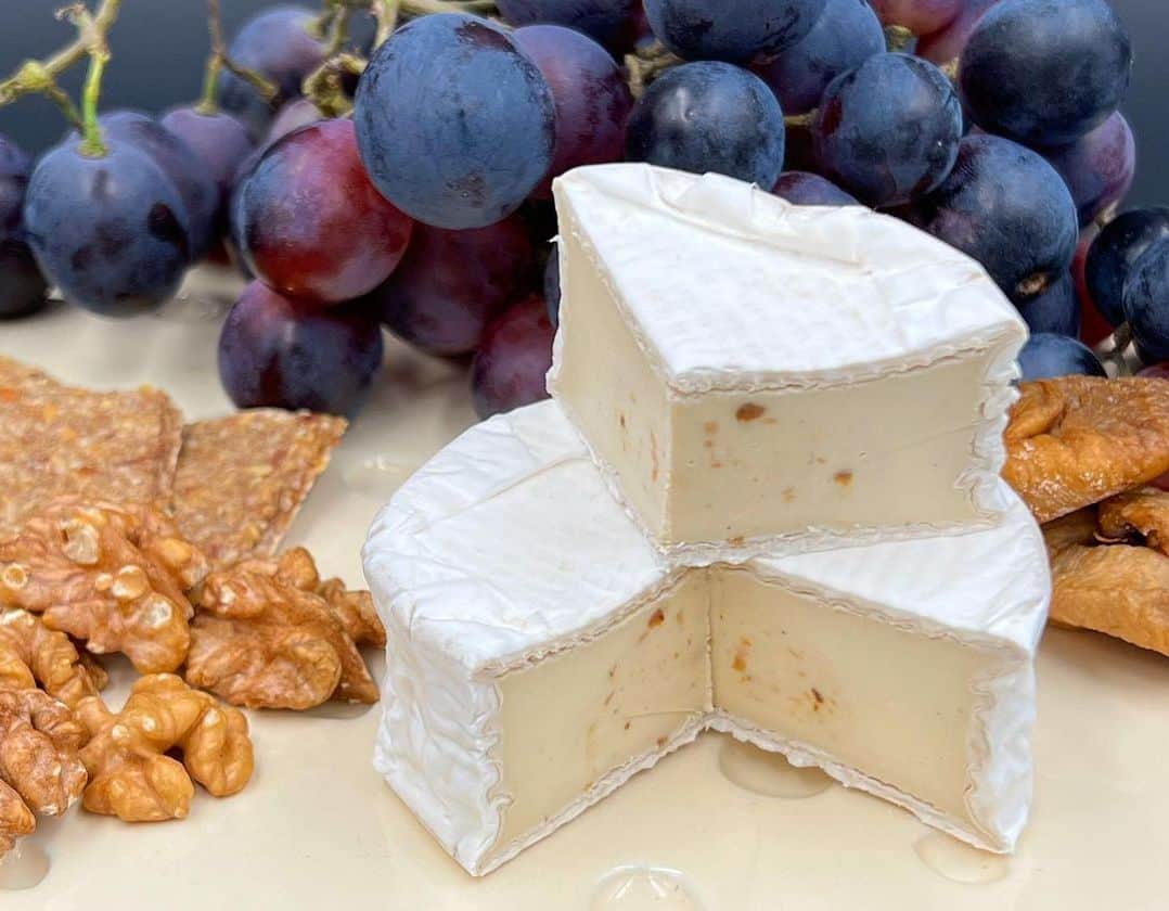 vegan camembert cheese served with nuts and grapes