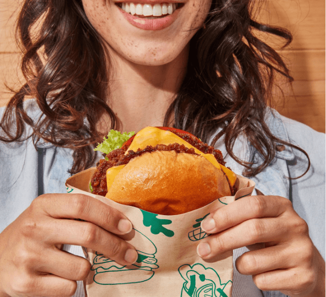 Hart House Girl Holding Vegan Burger