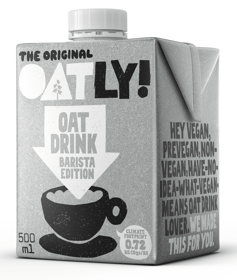 Oatly vegan oat drink Barista Edition in glass with carton behind and oats  strewn around on black background. Editorial use only Stock Photo - Alamy