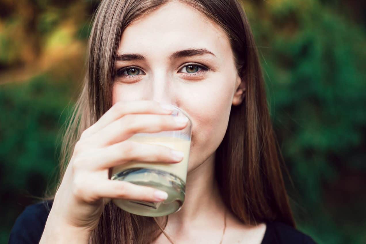 Woman drinking oat milk